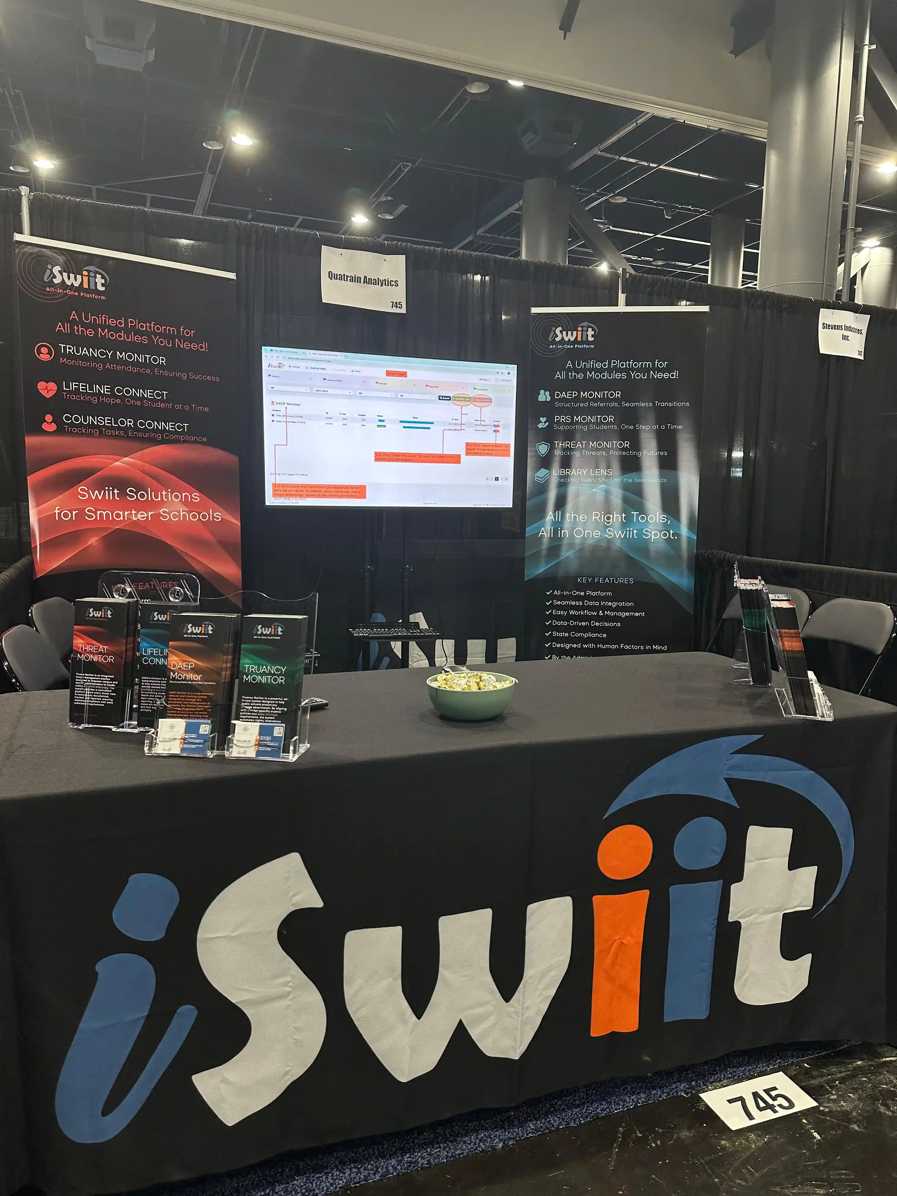 iSwiit booth at txEDCON 2025 with banners and live demo screen
